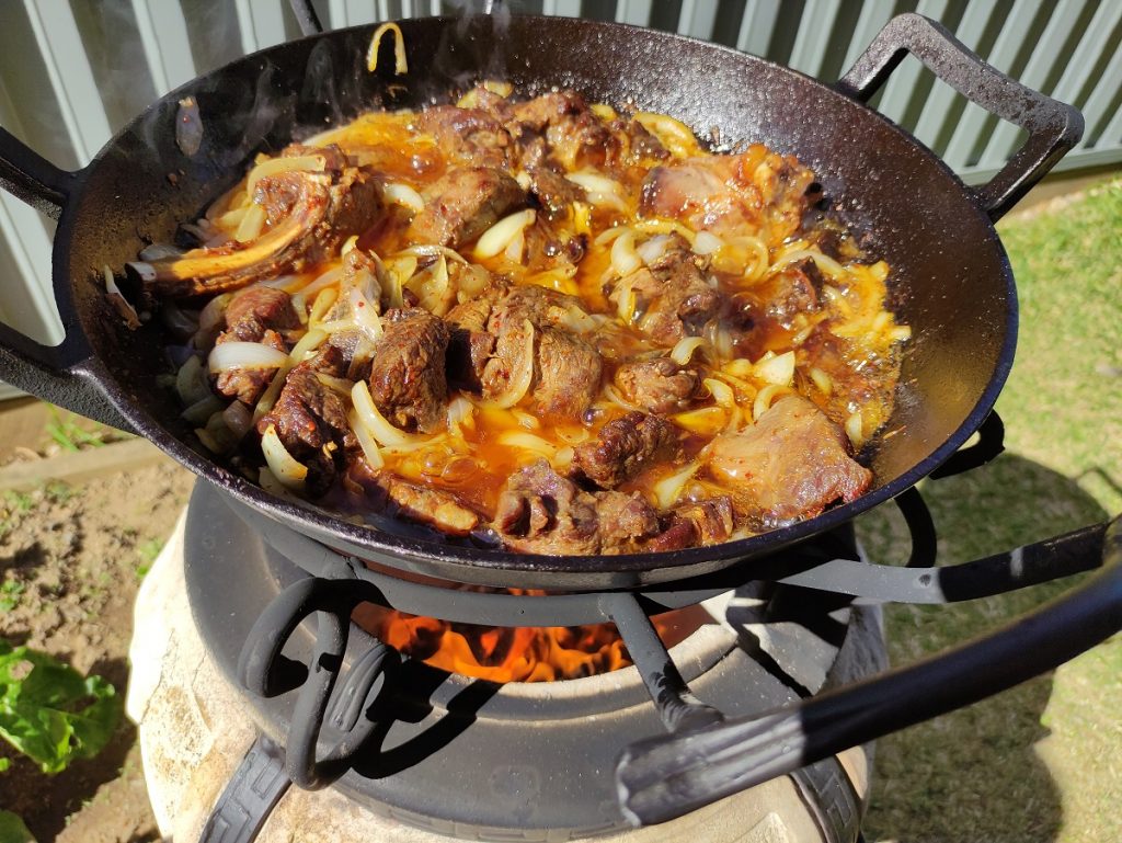 Frying meat and onions in the Cauldron